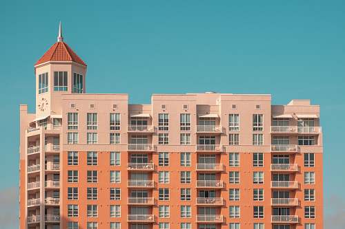 town orange and white concrete building at daytime urban